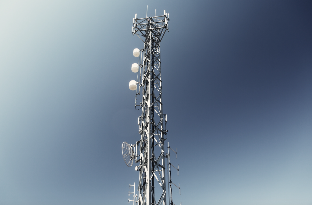 A cell tower with a blue sky in the background.